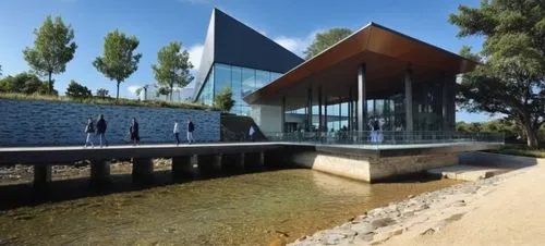 RIO ,people walking in the dirt outside of a modern building,aqua studio,siza,k13 submarine memorial park,snohetta,bjarke,house by the water