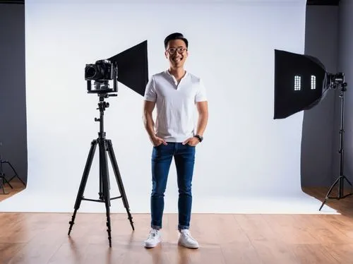 Photography studio, professional camera equipment, LED lights, reflectors, backdrops, wooden floor, modern minimalist interior design, solo male photographer, 30s, casual wear, jeans, white shirt, sne