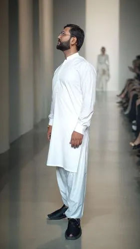 a man with beard in white outfit standing on the runway,emirati,hajj,mutairi,mutawakil,haj,mashallah