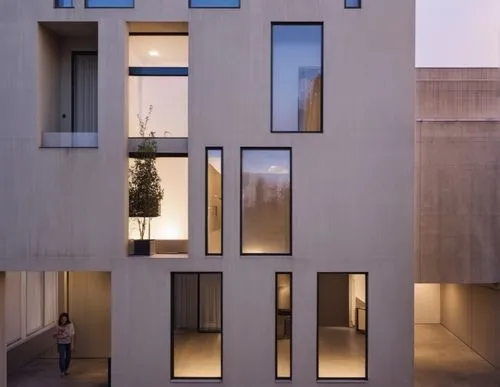 set the cars 
 concrete wall
show street  
street background
street line 
green roof
chair in terrace
black window frame,a tall gray building with windows on one side and a woman standing outside,cubi