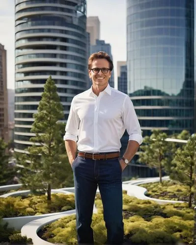 Michael D'Angelo, landscape architect, standing, confident posture, casual business attire, white shirt, dark blue jeans, black glasses, short brown hair, gentle smile, holding a large scale model of 