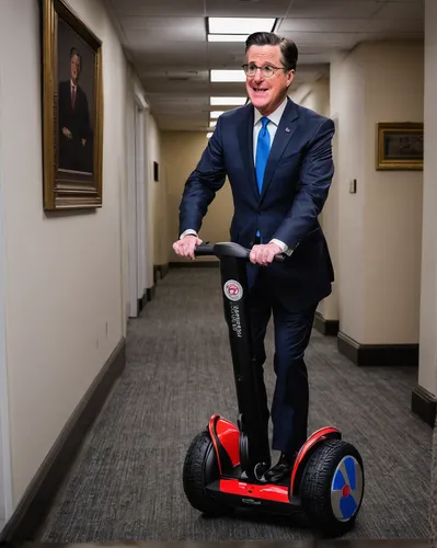 Stephen Colbert rides a Segway down the hallway outside of Rep. Adam Schiff's office in the Rayburn House Office Buidling on Tuesday, Feb. 13, 2018. Colbert was on Capitol Hill for an interview with R