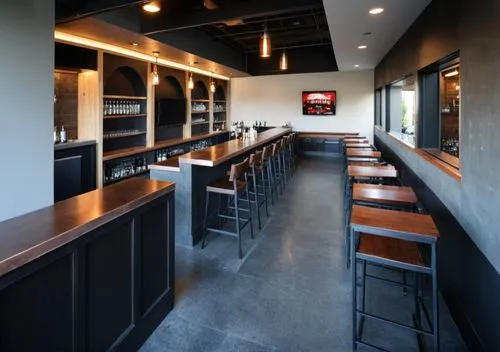 A friendly neighborhood bar, dark concrete flooring, televisions, copper countertops,the inside of a restaurant with stools and a bar,taproom,wine bar,chefs kitchen,bar counter,liquor bar,servery,Phot