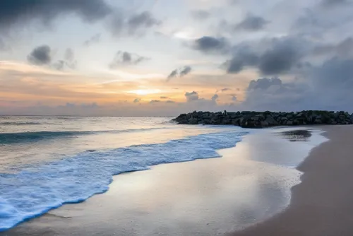 the beach is clean and has a few waves coming in,sunrise beach,beach landscape,beautiful beaches,beautiful beach,beach scenery,caribbean sea