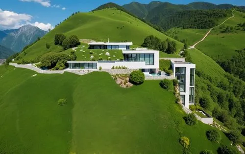 modern minimalist high-end architecture.Exterior. A landscape with green mountains in the background,a large modern home perched on a hillside,house in the mountains,house in mountains,building valley