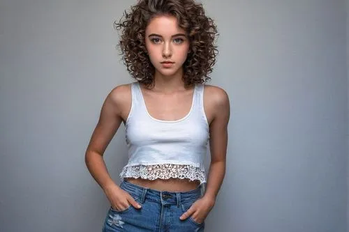 Big eyed model, solo, (18yo), beautiful detailed eyes, double eyelids, thick eyelashes, light blush, shoulder length curly brown hair, natural makeup, fitted white tank top, high waist denim shorts, s