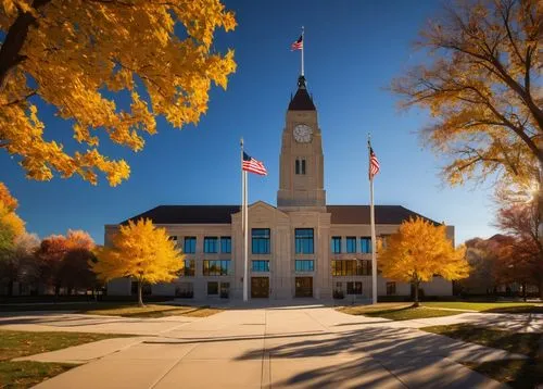 Nebraska City Hall, modern architectural design, grand entrance with glass doors, symmetrical stone facade, clock tower, ornate details, American flags, city square, autumn trees with yellow leaves, a