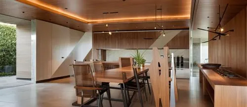 INTERIOR DE UN COMEDOR CON UNA ISLA CON ESTUFA TERMOMAGNETICA, CON UN GRAN VENTANAL A UN JARDIN EXUBERANTE, LUMINARIAS MODERNAS, PERSONAS,the wooden table in the dining room is surrounded by brown cha