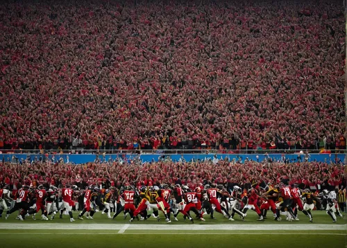 Create a poem capturing the excitement and energy of a football game.,the sea of red,buckeyes,the atmosphere,red sea,canadian football,football stadium,football field,university of wisconsin,eight-man