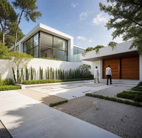 two men stand in front of a modern home,prefab,modern house,fresnaye,fromental,prefabricated,piramal