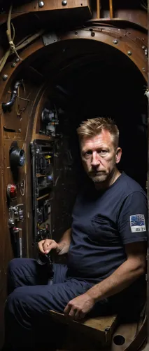 Kim Wall's accused killer Peter Madsen inside his homemade submarine the Nautilus in 2008. Picture: Niels Hougaard /Ritzau via AP,mechanic,aquanaut,engine room,daniel craig,iss,konstantin bow,car mech