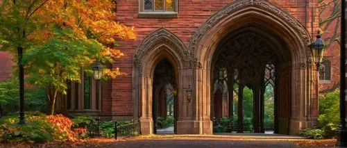 Historic university building, University of Pennsylvania, Philadelphia, Ivy League, Collegiate Gothic style, ornate stone carvings, grand entrance archway, pointed towers, stained glass windows, red b