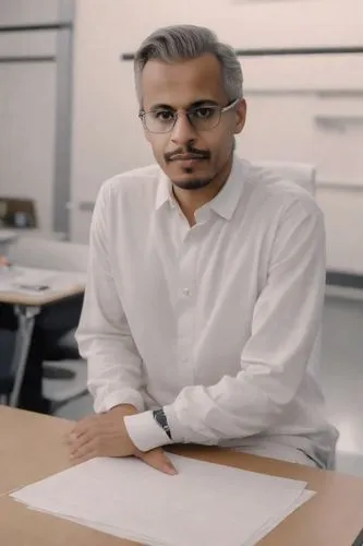 man sitting at desk writing in front of papers,pichai,shahbaz,hirani,aboudihaj,zaheeruddin,alvi,Photography,Realistic