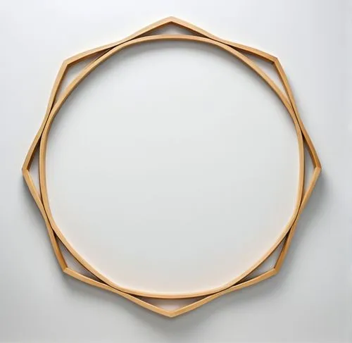 A frame made of wood against a white background,a wooden plate is shown with a circular cut out of the top,circle shape frame,circular puzzle,wooden rings,heart shape frame,semi circle arch,bamboo fra