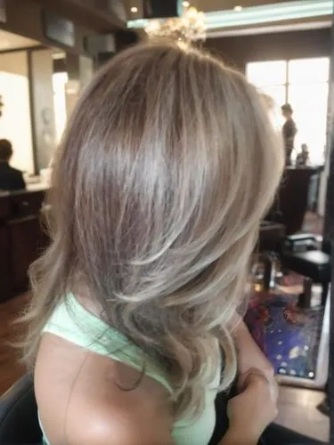 she is sitting alone in a beautiful hair salon,natural color,hair coloring,champagne color,caramel color,blonde,smooth hair,color 1,short blond hair,layered hair,trend color,gray color,back of head,ha