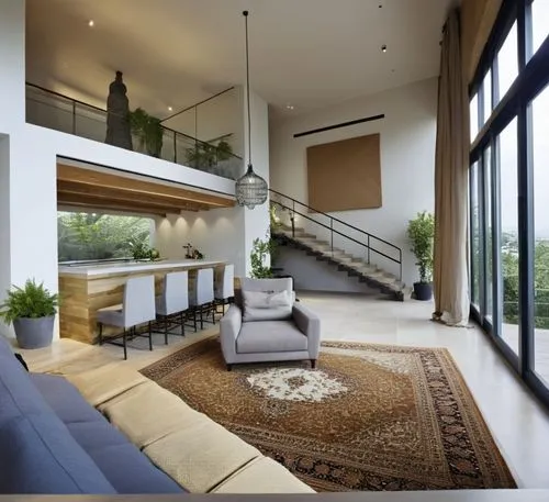 As the sun sets behind a spacious interior, a minimalist style loft, showcasing an eclectic mix of architecture and decor. The room is filled with the plush cushions and sleek surfaces that contrast b