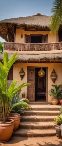 Traditional Ghanaian house, African architectural style, mud-brick walls, thatched roof, ornate wooden doors, colorful textiles, vibrant patterns, intricate carvings, tropical plants surrounding, palm