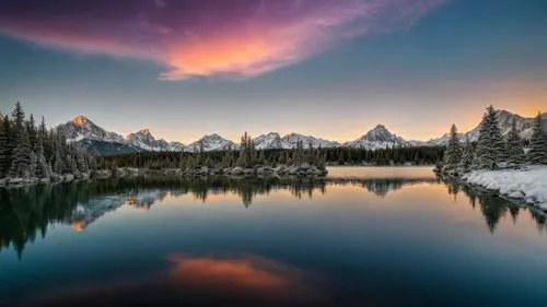 beautiful dramatic sunset with purple cloud and lake deflection. on the lake, there are fishes jumping out of water,canadian rockies,moraine lake,emerald lake,lake moraine,shuksan,snowy peaks,maligne 