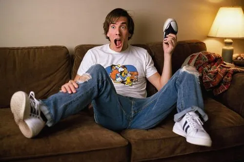 Goofy ah, comedy, funny facial expression, open mouth, tongue out, goofy eyes, messy brown hair, casual wear, relaxed fit, plain white t-shirt, ripped blue jeans, sneakers, leaning back, sitting on co