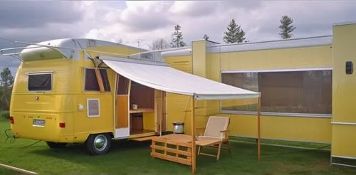 Finish the ceiling and walls with white paint, finish the floor with artificial turf and dark brown Herringbone tiles, make the camper a combination of yellow and white, place the bed inside the campe