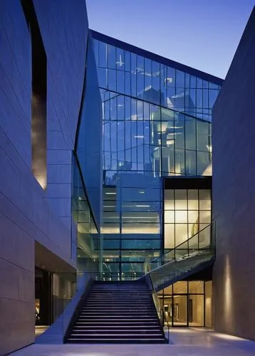 Modern museum, 2004 Smithsonian Architecture Design Award winner, sleek metallic exterior, large glass windows, angular lines, geometric shapes, urban cityscape background, night scene, soft illuminat