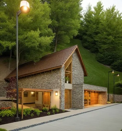 VISTA EXTERIOR DE UNA CASA  CON ILUNICACION DE LA CIUDAD CON PERSONAS ,a house with garage and two cars parked on the driveway,ivillage,visitor center,rockbridge,crematorium,hovnanian,house in the mou