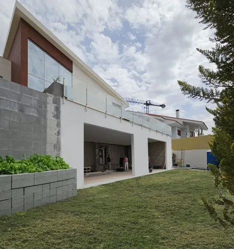 place a vegetable slope made with concrete blocks,residential house,modern house,dunes house,cube house,residential,cubic house,hause,archidaily,two story house,athens art school,modern architecture,i