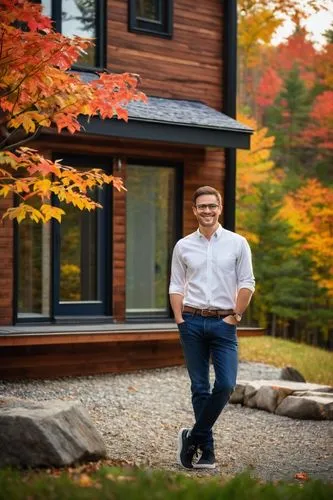 Male, architect, 30s, bespectacled, short brown hair, casual smile, white shirt, dark blue jeans, black sneakers, holding a large portfolio, standing in front of a modern New Hampshire house, wooden e