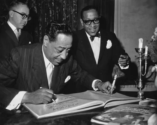 Duke Ellington signs his biography in London in 1958, with Billy Strayhorn in the background. Ellington and Strayhorn collaborated to create 1960's The Nutcracker Suite.,art tatum,13 august 1961,a bla