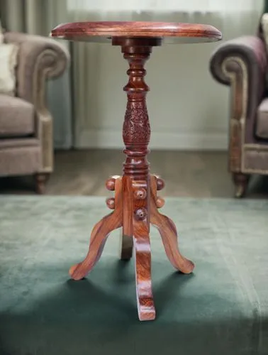 item placed as a side table on side of sofa as a luxurious good ,a small wooden table with carvings on top,antique table,coffee table,coffeetable,dining room table,wooden table,set table