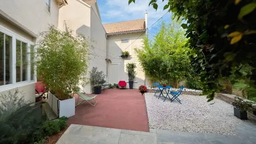 a back yard with a hammock set up on the ground,patio,patios,inside courtyard,courtyard,courtyards,terrasse