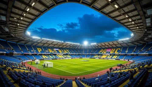 Vibrant sports stadium, bold color scheme, energetic atmosphere, bright floodlights, electric blue seats, sunny yellow accents, deep green turf, modern architectural design, sleek metallic structures,