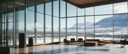 Utah-inspired futuristic architecture, competition-winning design, grand glass atrium, sleek metallic exterior, snow-capped mountain backdrop, modern asymmetrical structure, cantilevered floors, floor