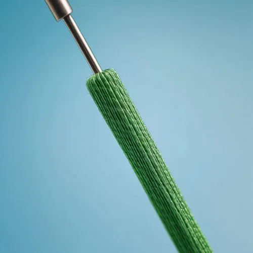 A large sewing needle with green thread threaded through it,darning needle,sewing needle,knitting needles,spikelet,to knit,the nozzle needle,knitting wool,cockscomb,rope brush,dilator,pipette,microele