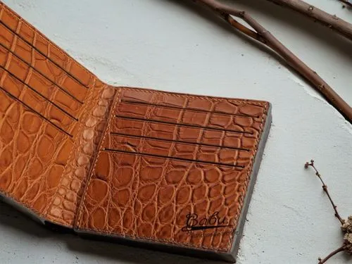 there is a wallet with a notepad in it,leatherwork,leather goods,embossed rosewood,crocodile skin,wallets,leather texture