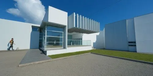 a person walking down a street next to a tall building,epfl,cubic house,modern building,documenta,maxxi,bauhaus,Photography,General,Realistic