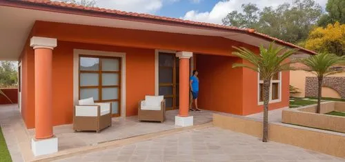 UNA CASA ESTILO MEXICANO, CON COLORES VIBRANTES, USO DE CANTERA,PISOS DE BARRO ROJO, TABIQUE Y ELEMENTOS REGIONALES MEXICANOS, UBICADA EN UN ENTORNO CAMPIRANO, CON COLUMNAS CIRCULARES DEE CONCRETO, AR