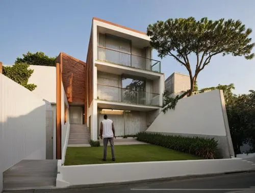 DISEÑA EL EXTERIOR DE UN EDIFICIO DE DAPARTAMENTOS ESTILO  MINIMALISTA, CON ACABADOS EN MURO DE COLOR BLANCO  Y CON MUROS EN TABIQUE APARENTE, CANCELES DE ALUMINIO CON CRISTAL, AMBIENTACIÓN CON PERSON