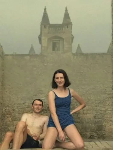 man and woman posing in front of an ancient building,a man and woman in swimsuits sit on stone steps,french tourists,chabrol,boyard,servalan,rivette,sokurov,Photography,Black and white photography,Bla