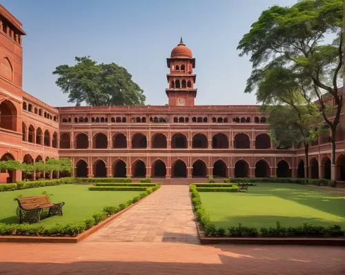 Modern Indian Institute of Technology college building, red brick exterior, grand entrance gate, sprawling green campus, tall trees, lush lawns, students walking in casual wear, backpacks, books, lapt