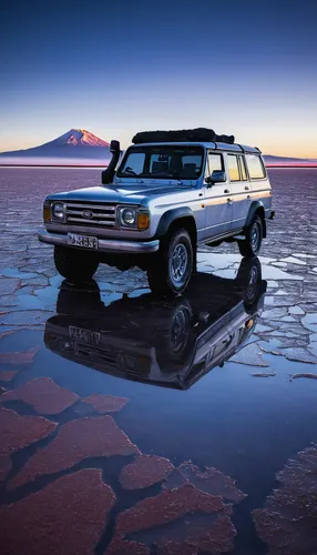 A 4x4 rests in the early AM reflection in the flooded Salar de Uyuni in Bolivia during the rainy season.,salar de uyuni,the salar de uyuni,jeep wagoneer,salt flats,salar uyuni,salt-flats,ford bronco i