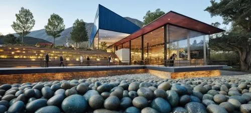 pasto, piedras, rio,a very nice building that has some rocks on the ground,cubic house,modern house,cube house,pool house,modern architecture,dunes house