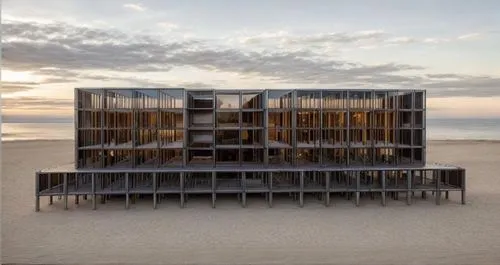 en la parte superior debe estar cerrado y lleva ventanales y terrazas, tambien lleva vegetacion y el terreno tiene un desnivel  ,a wooden structure in the middle of a beach,cube stilt houses,beach fur