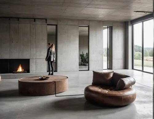 interior , sofa ,  living room ,minimal concrete ,a woman standing near a couch in a large room,minotti,natuzzi,lalanne,cassina,corten steel,bertoia,Photography,General,Realistic