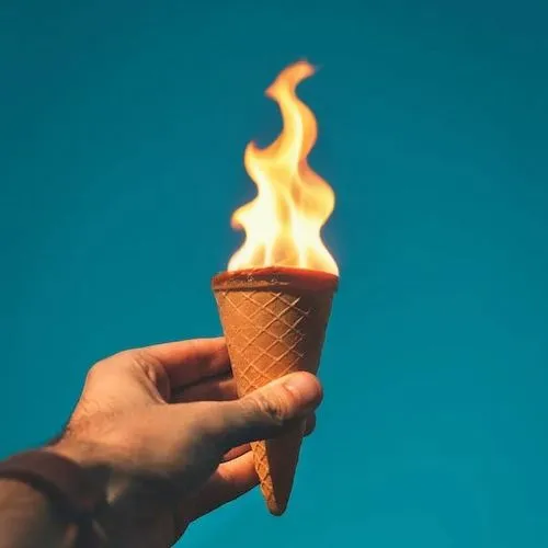 flame,someone holding an ice cream cone in their hand,aglycone,flaming torch,olympic flame,ice cream cone,cornetto,olympic torch