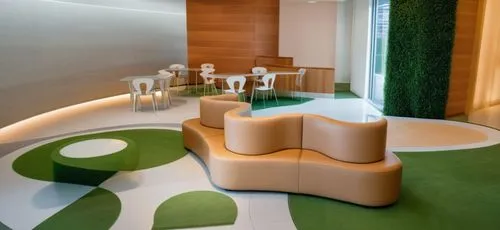 waiting room with a cafe area, a counter serving coffee with pastries. in the waiting room is Verner Panton – Canapé
Cloverleaf lounge chair. A glass wall with a view of the city opens in the cafe are