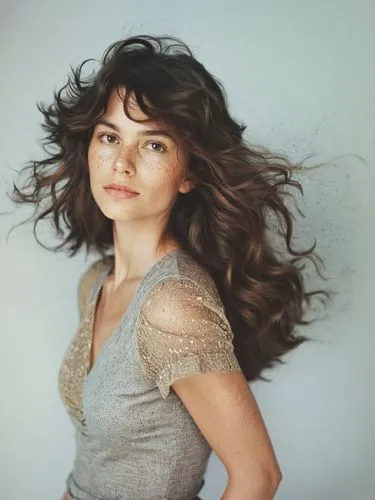 a woman with long, wavy brown hair,a woman that is standing in a po studio,scherfig,beren,voluminous,zooey,pantene,deschanel,Photography,Documentary Photography,Documentary Photography 11