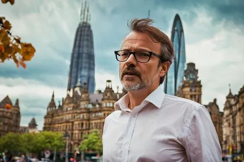 Middle-aged man, architectural designer, Bradford, England, standing, confident posture, black-framed glasses, short brown hair, trimmed beard, white shirt, rolled-up sleeves, dark blue jeans, leather