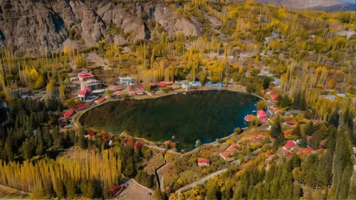 a mountain village is situated on the top of a lake,tianchi,emerald lake,skardu,passu,heaven lake,crater lake