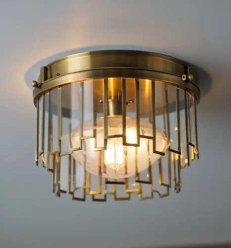 textured thick clear glass flush mount finish in antique brass,a small golden cage light hangs above the bed,ceiling light,halogen light,ceiling lamp,halogen spotlights,sconce,ensconce,wall light,cuck